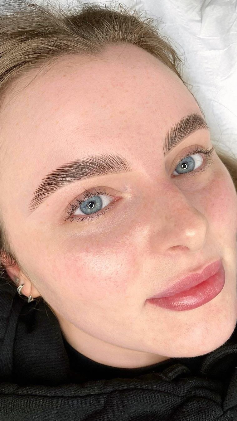 a woman with blue eyes and eyebrows