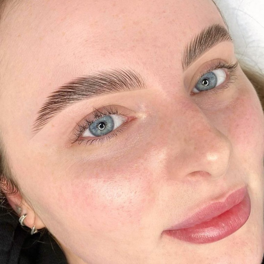 a woman with blue eyes and eyebrows